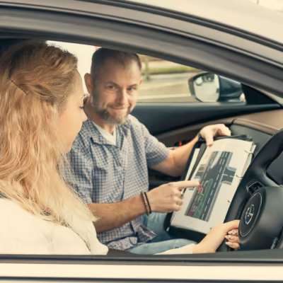 Marcin explaining a junction using a diagram to a learner in the car
